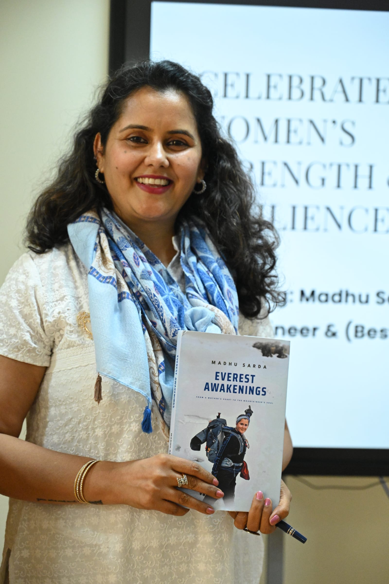 Madhu Sarda holding her bestselling book Everest Awakenings at the ACME Women's Strength and Resilience event